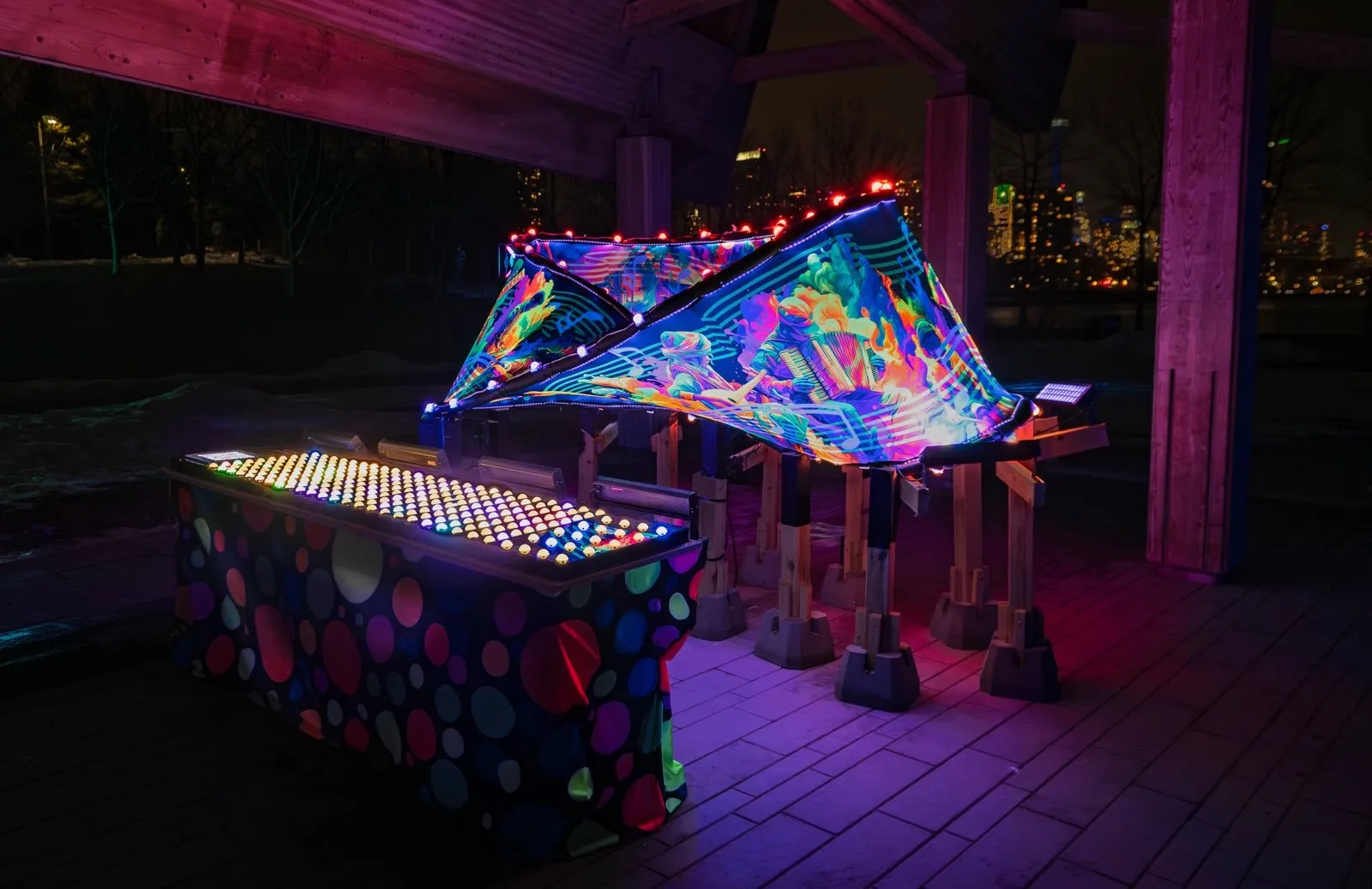 The glowing Möbius Ensemble sculpture and interactive controls at night